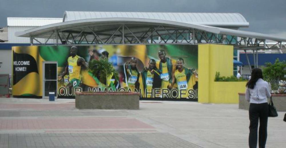 Norman Manley Airport, Kingston: KIN (NMIA). mural  Our Jamaican Heroes at airport: Usain Bolt, Asafa Powell, Shelly-Ann Fraser